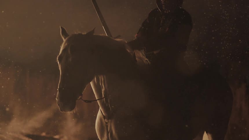A man on horseback is holding a sword