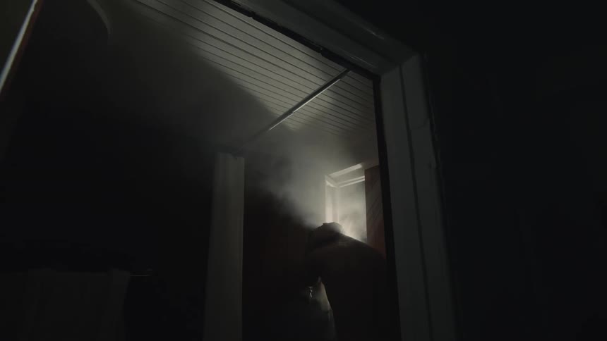 A man showering in a steamy shower