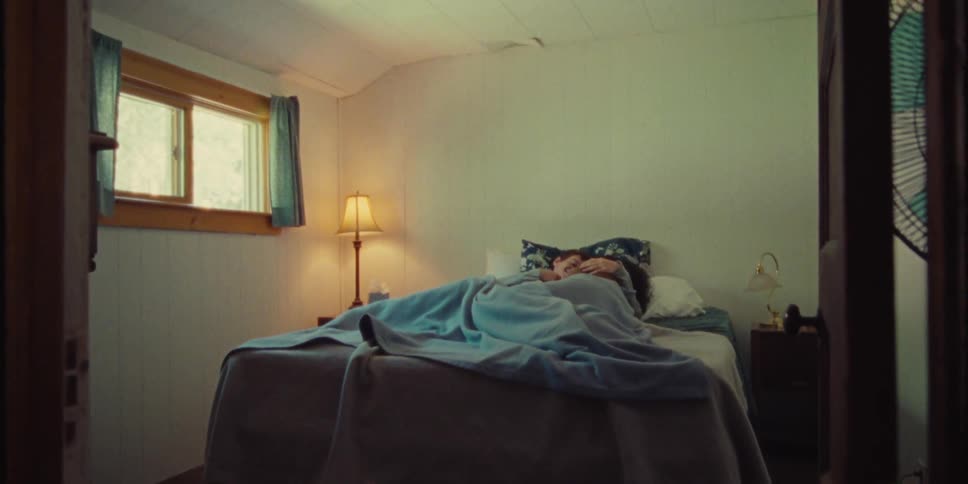 Young couple lying together on a bed in the bedroom during the day