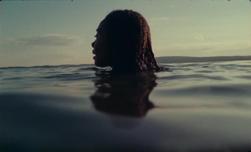 A scared looking woman treading water in the sea