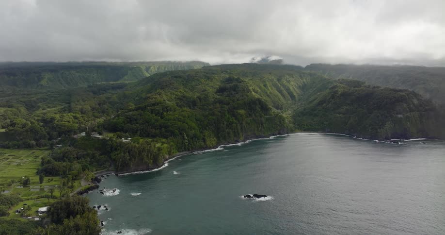 Gentle waves crash onto the shore of an island