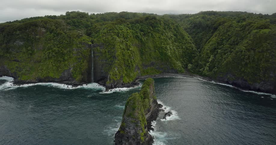 Aerial view of an island in the ocean water is displayed