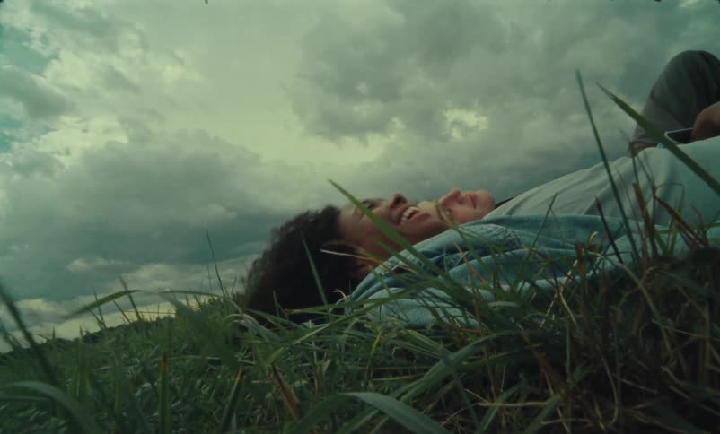 Man and woman are resting in the grass together