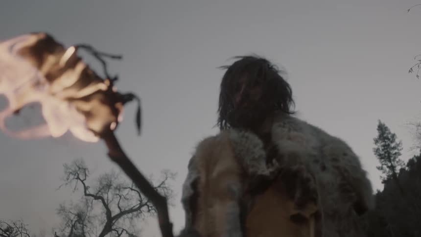 A man lifts a torch in front of him