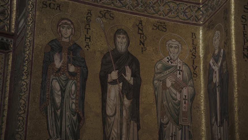 Painted images of saints are on a church wall