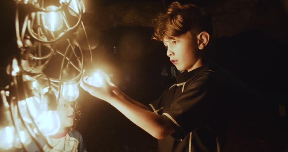 A boy and his sister help their father unravel string lights