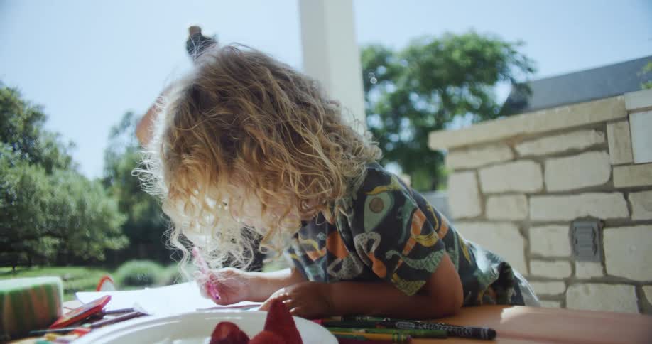 A person coloring outdoors