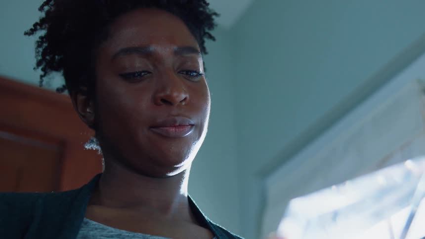 A woman looks at a plaque before putting it away