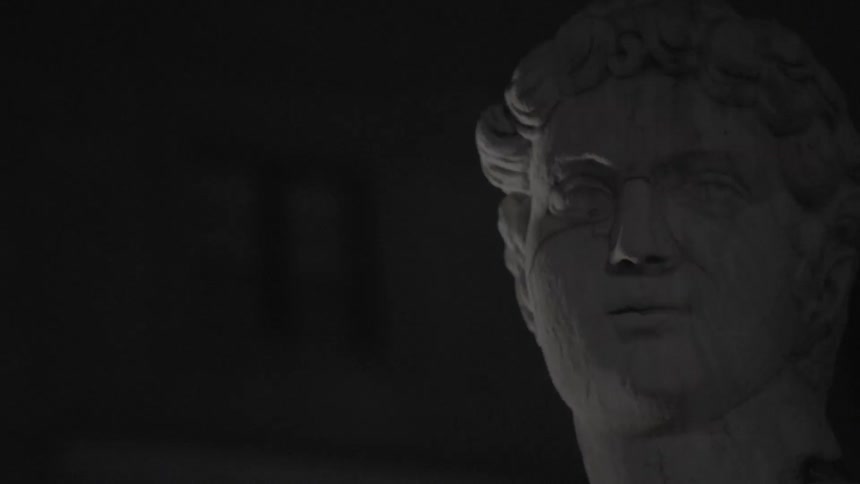 A cracked statue in a dark room