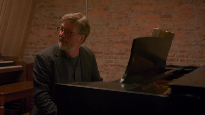 A man playing piano on a stage