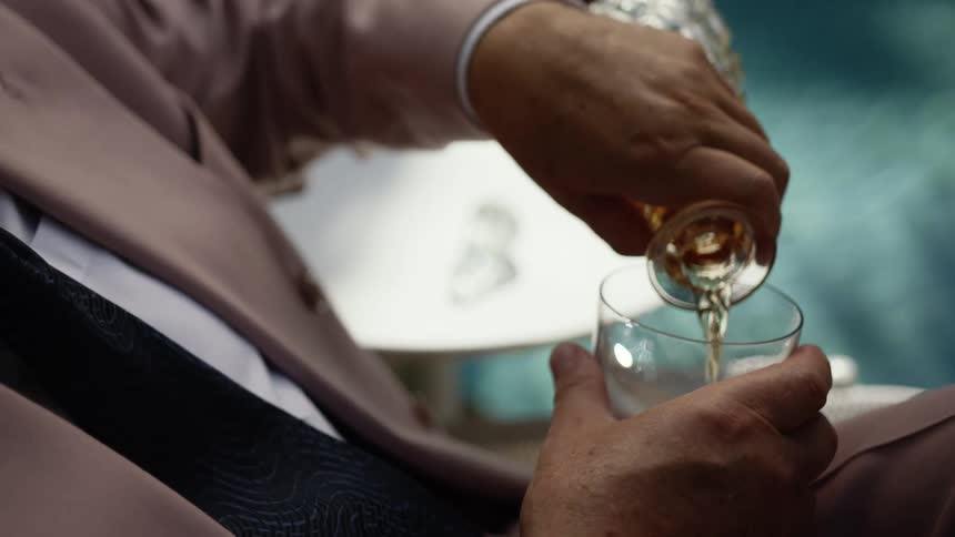 A person pouring a drink outdoors
