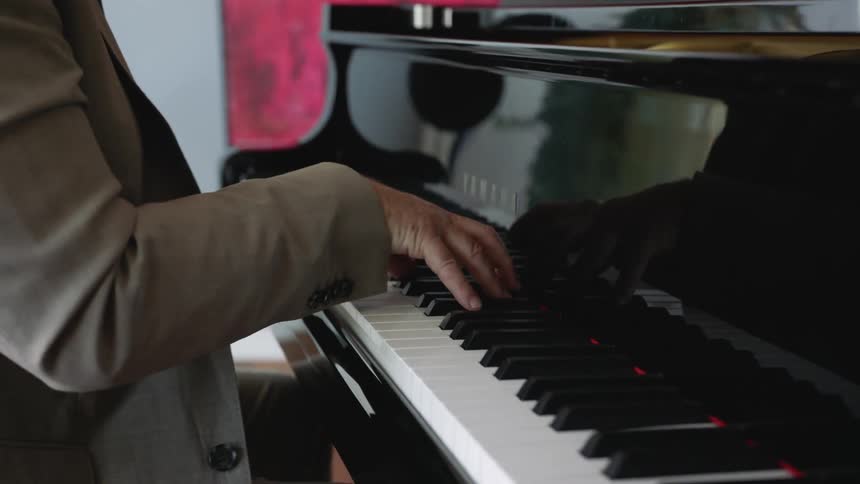 A man playing piano in a room