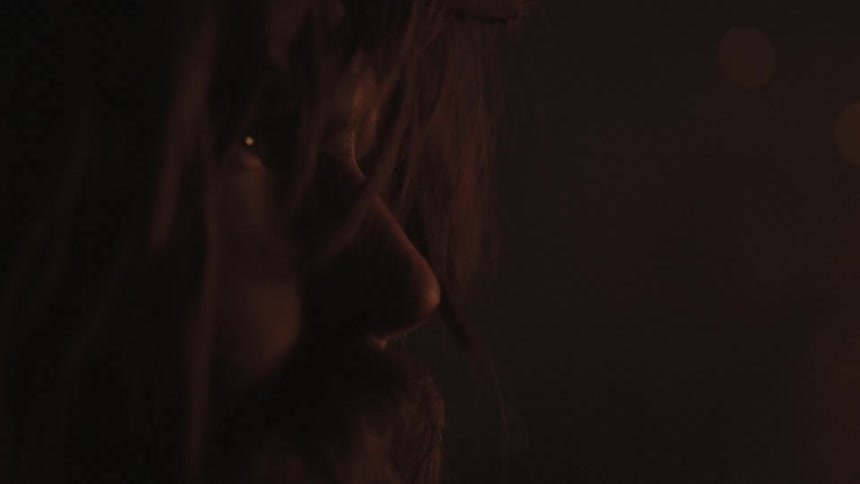 A man sits in the dark looking ahead