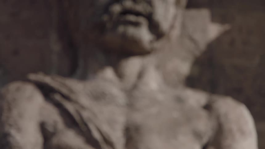 Weathered and worn statue outside of building