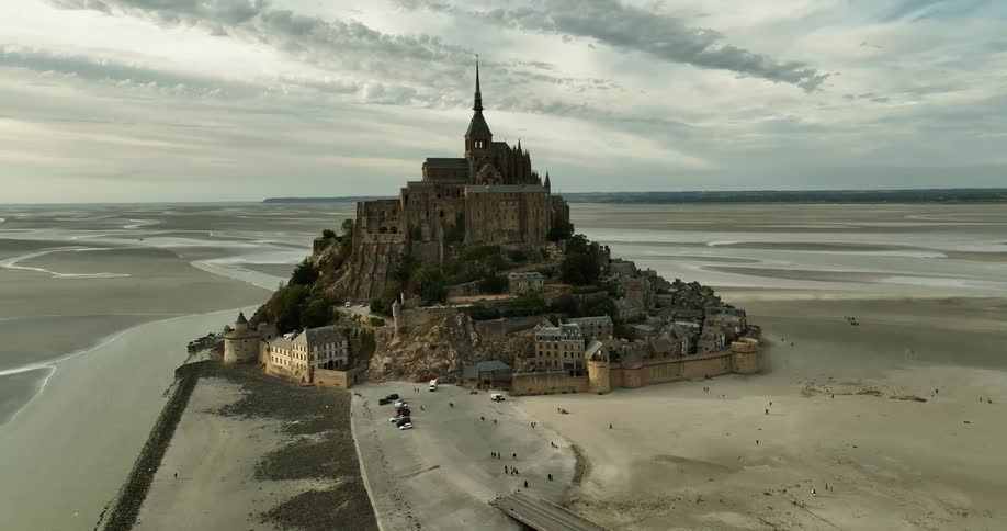 Old walled city sits on plain near river under cloudy sky