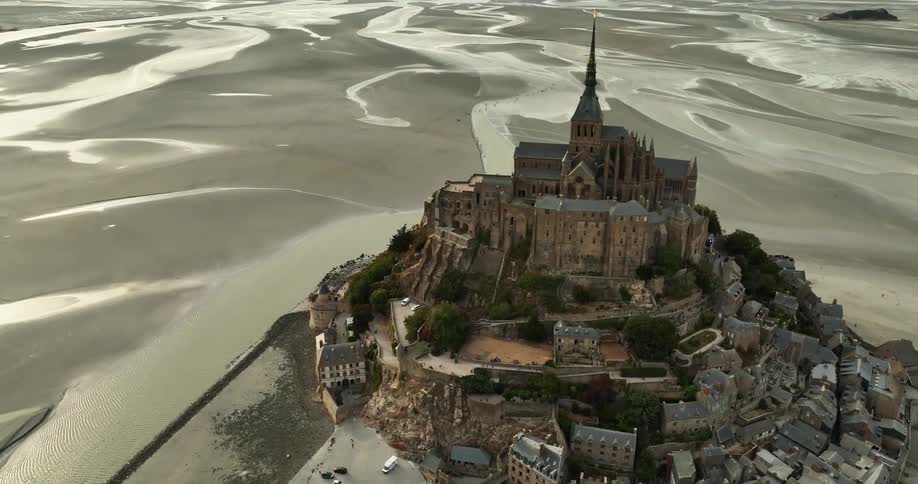 A castle and town is surrounded by sand