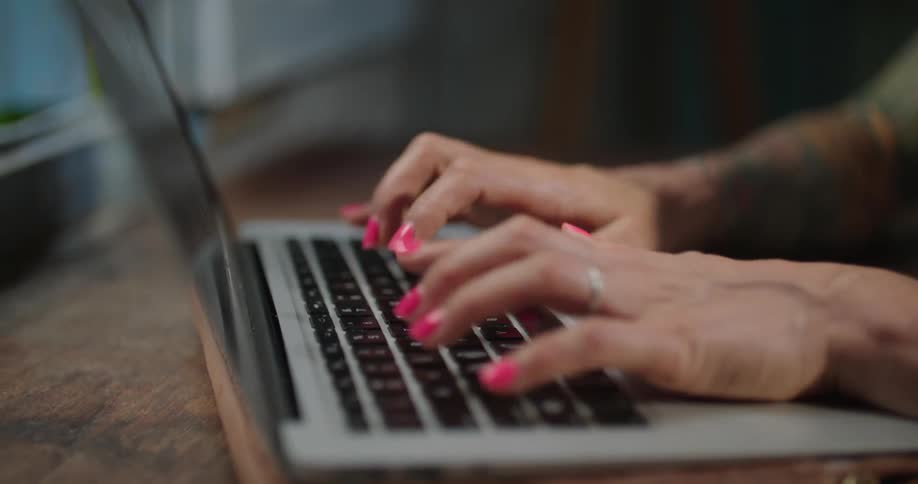 A person is typing on the laptop