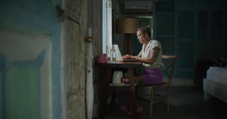 A woman is typing on the laptop