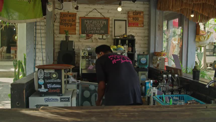 Coffee shop owner prepares coffee on an espresso machine