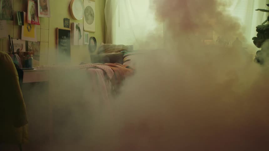 The room fills with smoke as the woman sleeps
