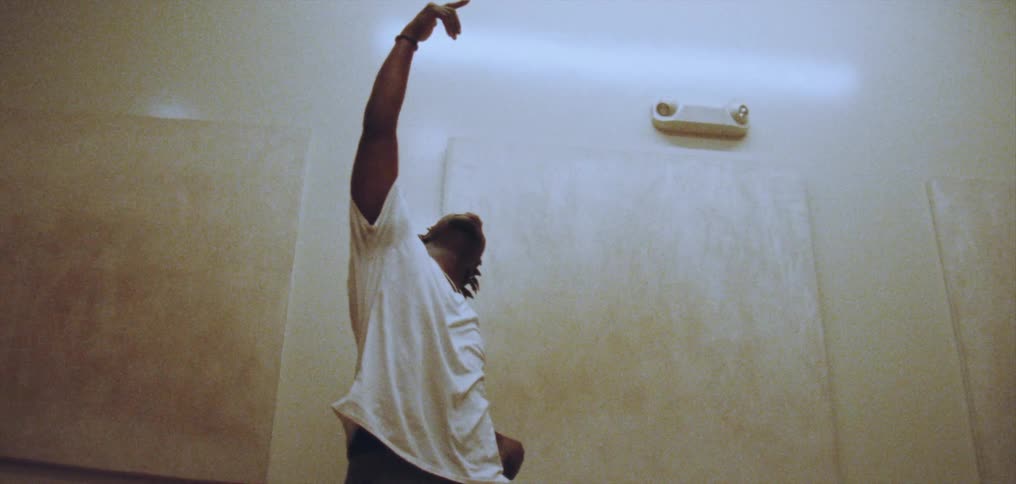 A man dances hip hop style in a dance studio