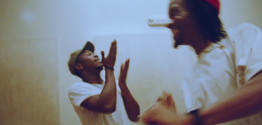 Group of happy people performing a choreographed dance on a room