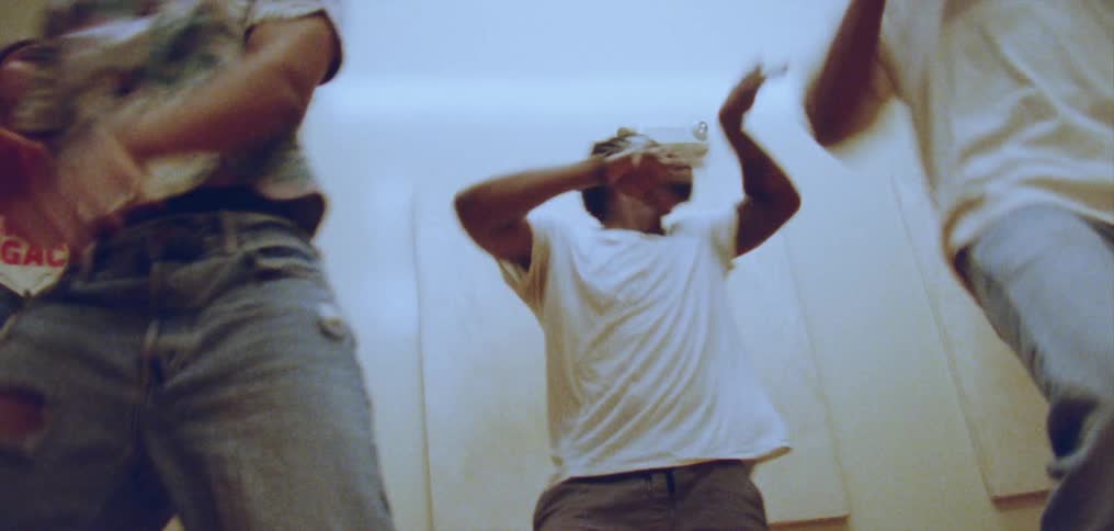 A group of dancers perform a synchronized dance together indoors