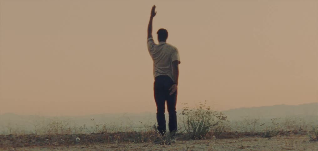 Male dancer with white shirt and black pants dances in the country