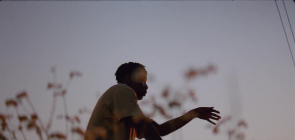 A young man dancing moving his arms and hands with the music