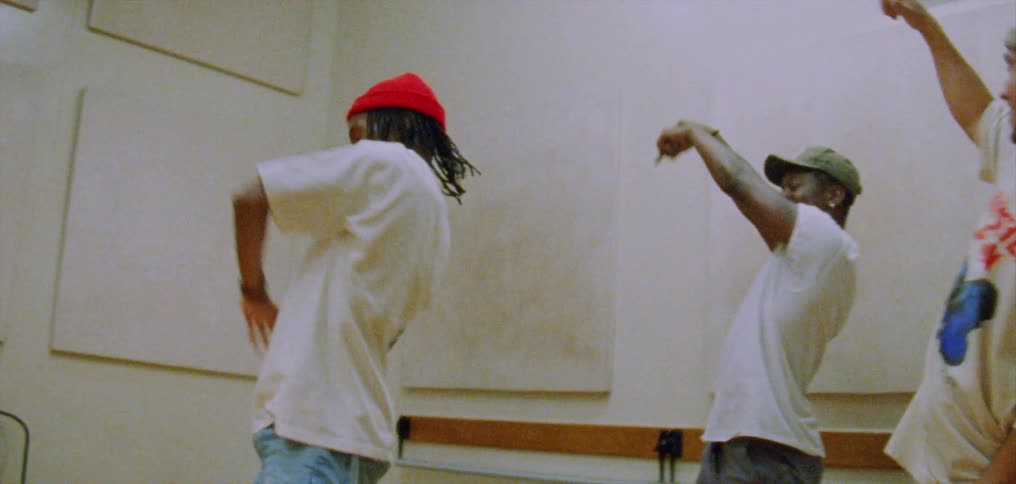 Group of happy people performing a choreographed dance on a room