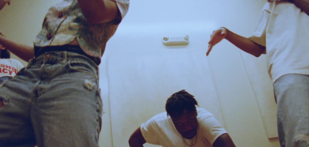 Group of happy people performing a choreographed dance on a room