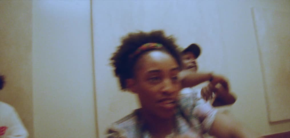 A group of 4 people are dancing inside of a room