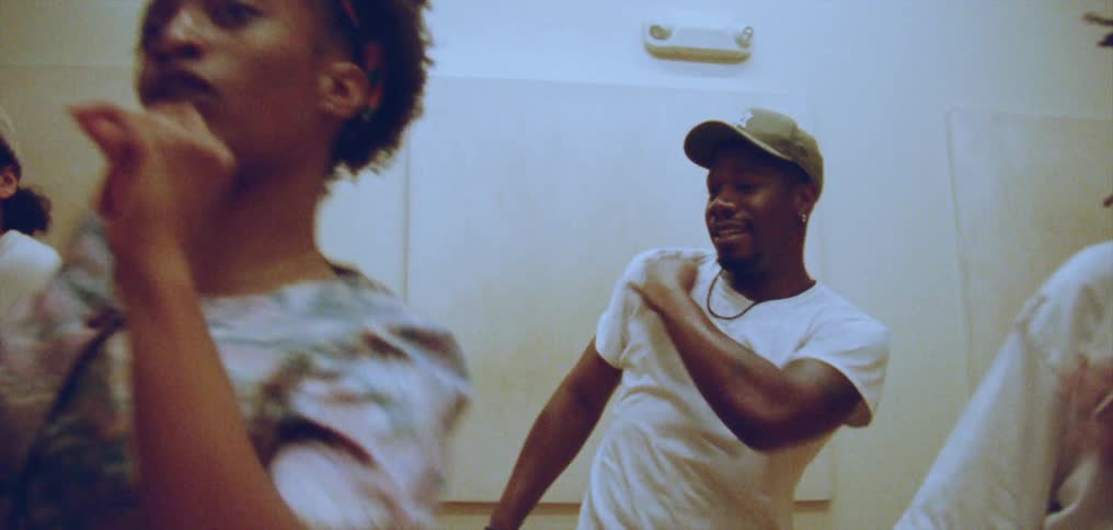 Group of happy people performing a choreographed dance on a room