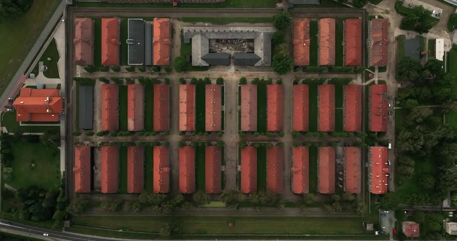 A birds eye view of rows of buildings with red roofs