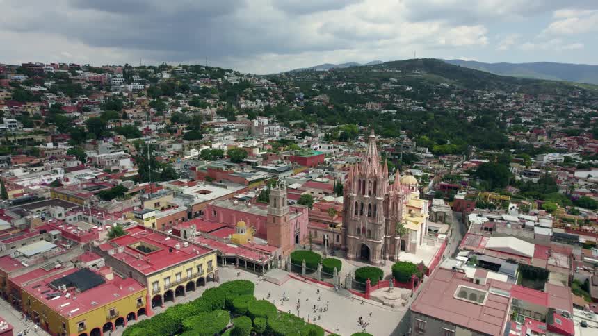 People walking on the square in front of parroquia de san miguel arcngel church