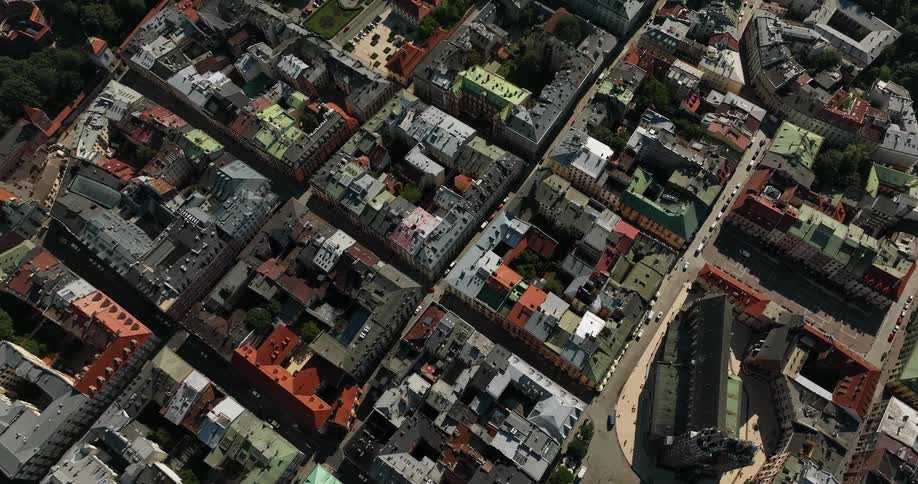 Traffic moves along streets between buildings formed around courtyards
