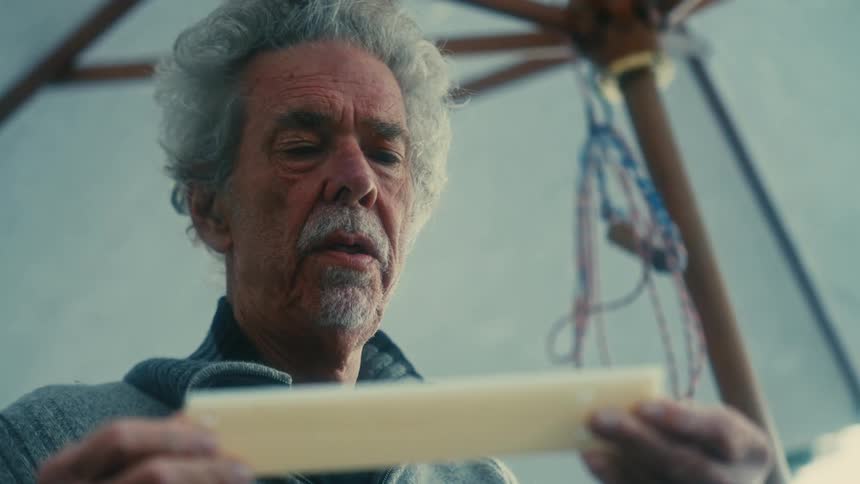 A man is standing outdoors and holding an object
