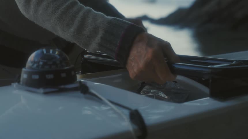 A man putting things onto a kayak