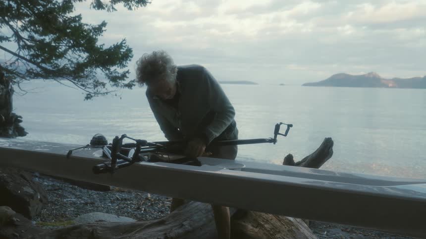 A man is working on his canoe