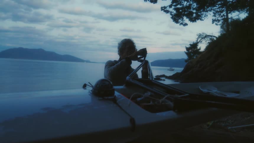 A man is repairing his kayak