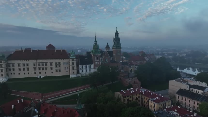 Heavy fog settles over a quaint town along a river