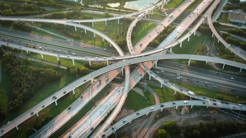 An aerial view of vehicles driving on a freeways