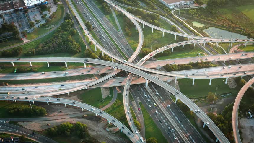 Traffic flows over network of highways and overpasses in urban area
