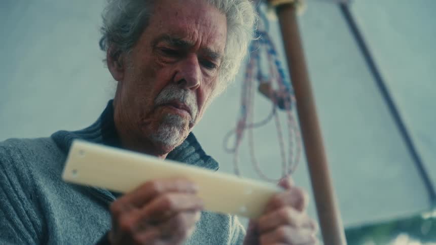 A man looks at an object in his hands