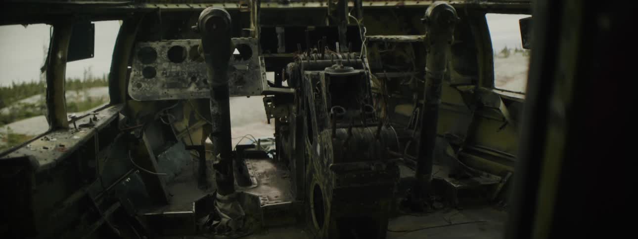 Cockpit on the dismantled interior of an abandoned airplane fuselage in the countryside