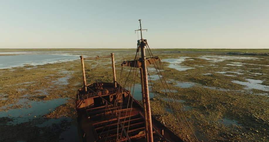 A shipwreck is on the sand
