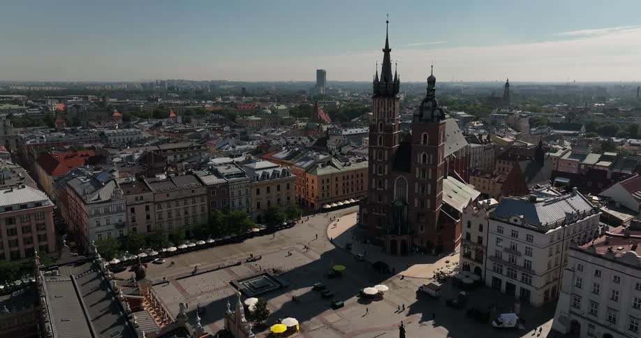 A large cathedral on a corner in a large city during the day