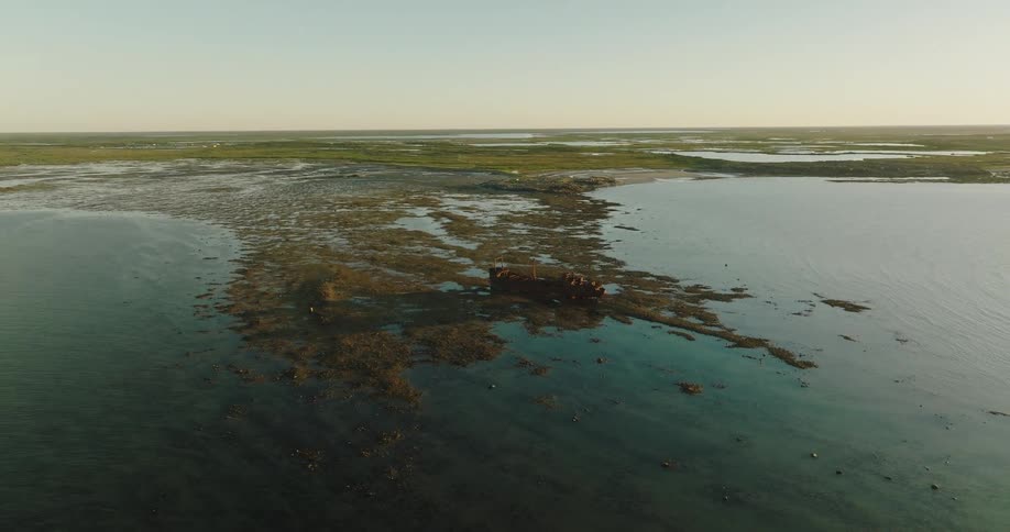 Aerial view of a body of water is displayed at dusk