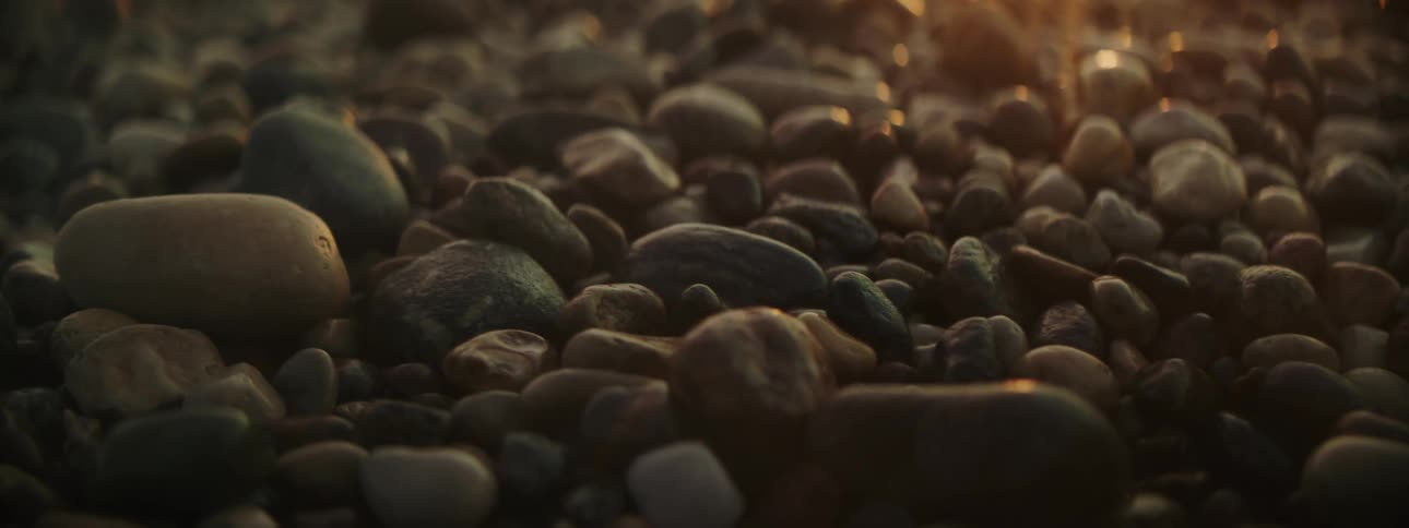 Sunlight shining on rocks and pebbles on the ground