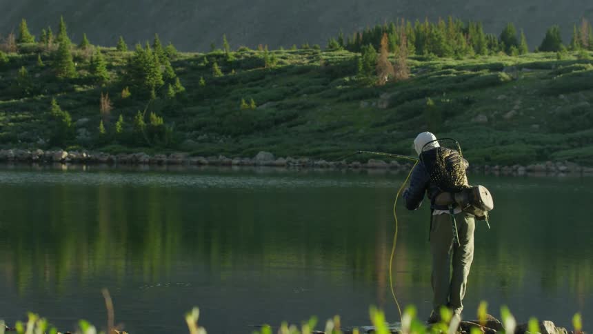 A person is outdoors and is fishing on the lake
